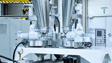 Coperion K-Tron single and twins screw feeders over an extruder inlet