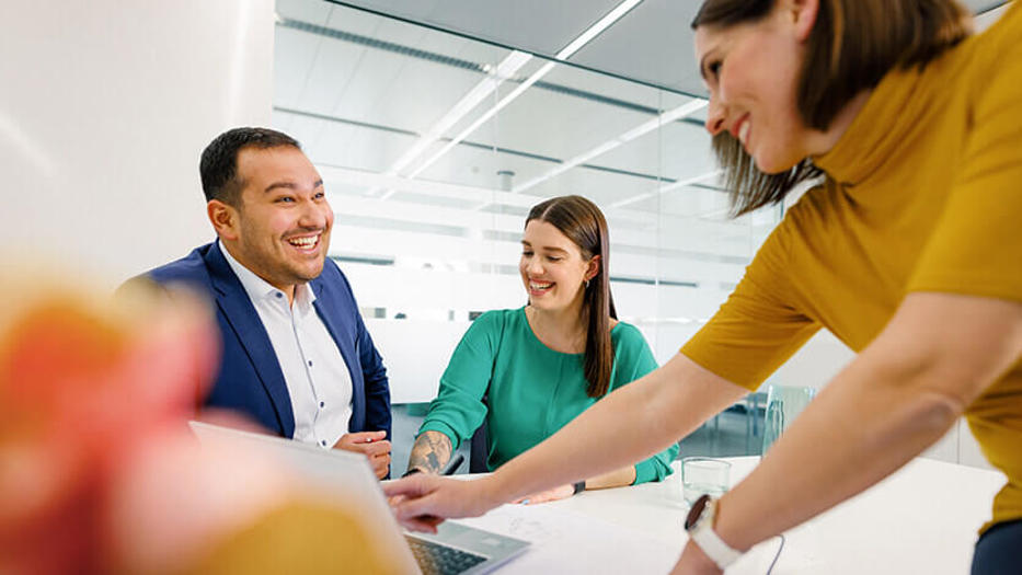 Coperion employees laughing in a meeting