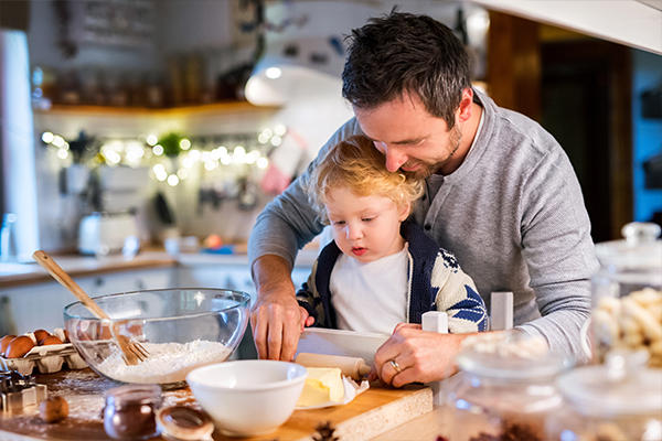 Dad baking cookies with kid